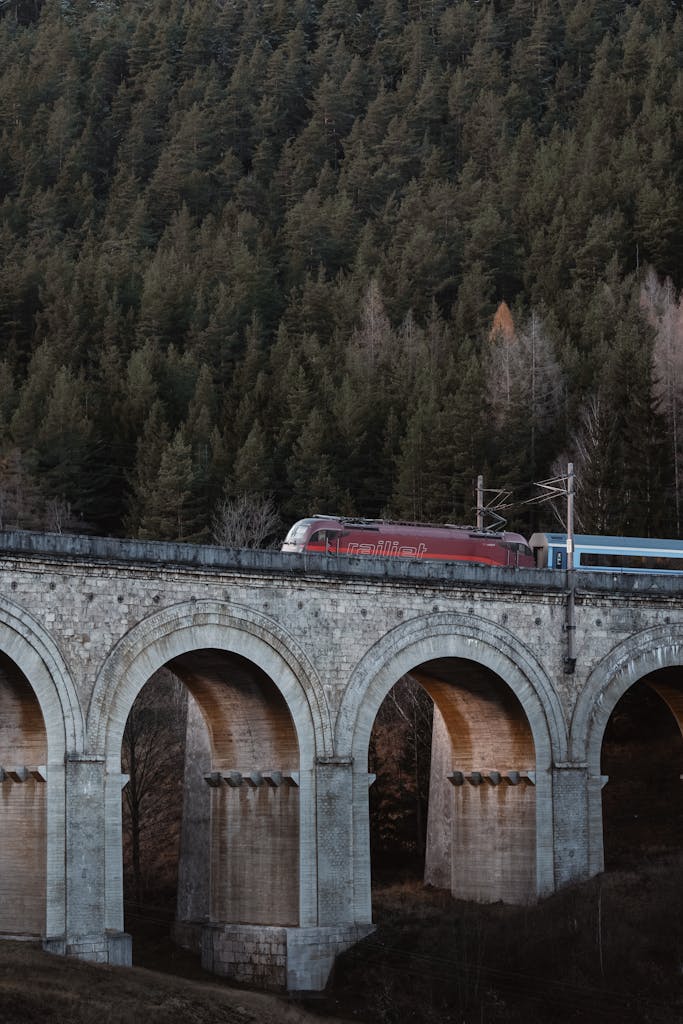 A scenic view of a train crossing the iconic Semmering Viaduct in Lower Austria.
